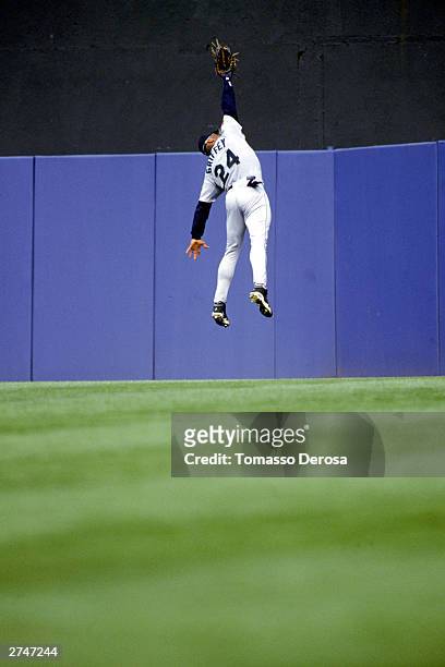 Ken Griffey Jr. #24 of the Seattle Mariners jumps to make a catch during the American League game against the New York Yankees at Yankee Stadium on...
