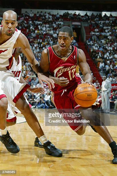 Kevin Ollie of the Cleveland Cavaliers drives to the hoop as Loren Woods of the Miami Heat guards him during the game on November 12, 2003 at...