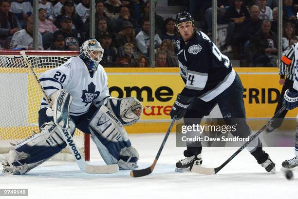 Ed Belfour of the Toronto Maple Leafs sets himself to make a save as Ryan Smyth of the Edmonton Oilers gets ready to tip a shot November 20, 2003 at...