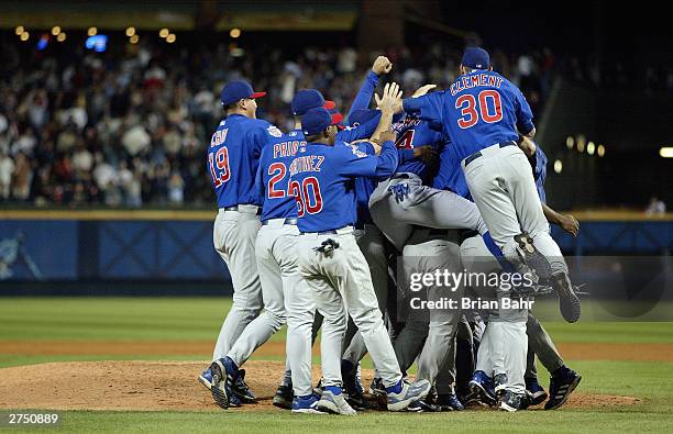 The Chicago Cubs pile up around the mound after the victory over the Atlanta Braves in game five of their National League Division Series on October...