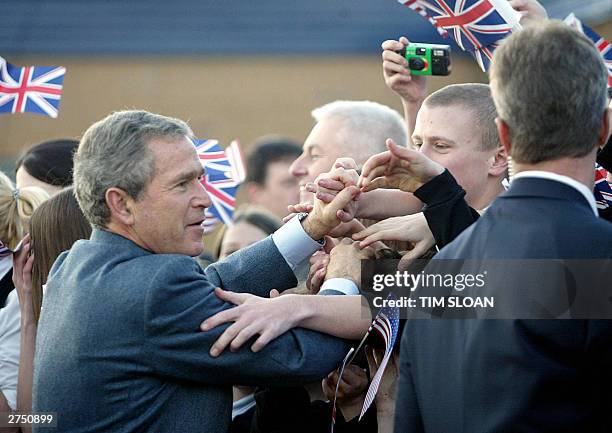 President George W. Bush greets supporters outside Sedgefield Community College in Sedgefield, 21 November 2003 during a visit with British Prime...