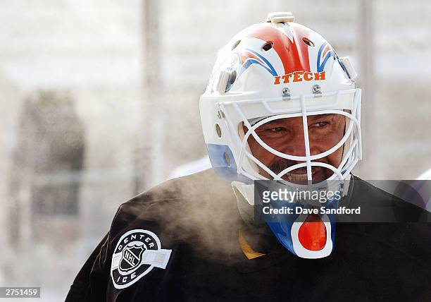 Grant Fuhr of the Edmonton Oilers Alumni takes a moment to catch his breath at outdoor practice in very cold temperatures November 21, 2003 in...