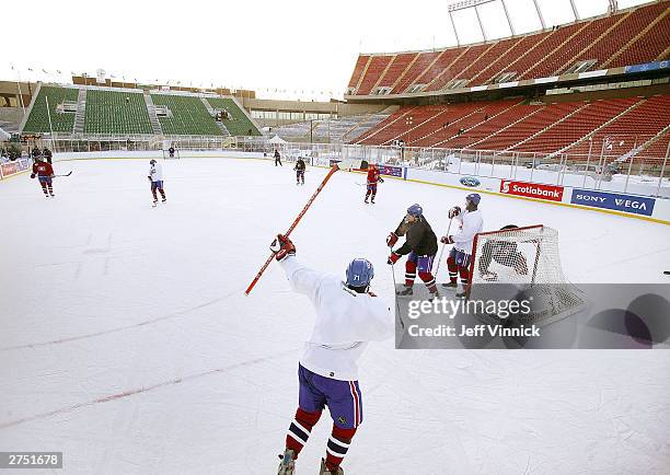 Mike Ribeiro of the Montreal Canadiens raises his arms as he celebrates a goal during a practice with his team on an outdoor rink on November 21,...
