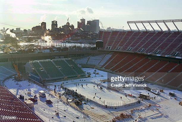 Below zero temperatures cause steam to billow up from buildings in downtown Edmonton off in the distance as the Montreal Canadiens practice on an...