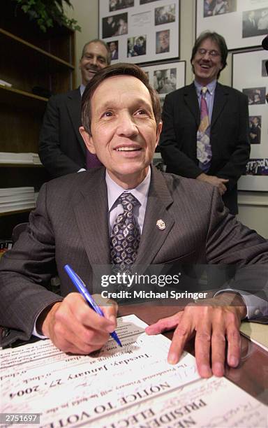 Rep. Dennis Kucinich fills out paperwork, officially entering the state's Democratic presidential primary at the New Hampshire Statehouse November...
