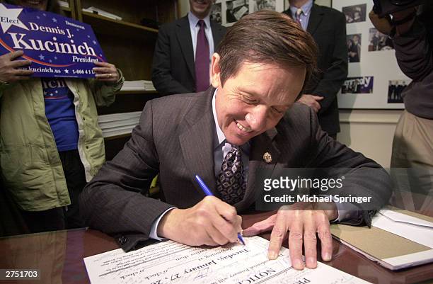 Rep. Dennis Kucinich fills out paperwork, officially entering the state's Democratic presidential primary at the New Hampshire Statehouse November...