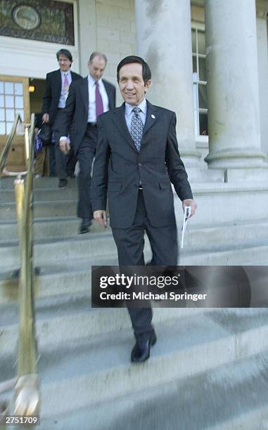 Rep. Dennis Kucinich walks out of the New Hampshire Statehouse after signing papers to officially enter the state's Democratic presidential primary...