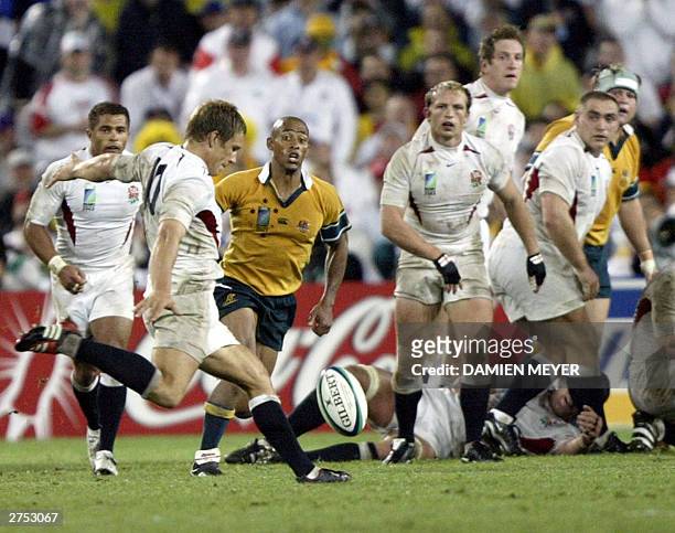 English fly-half Jonny Wilkinson kicks a drop goal while Wallaby captain and scrumhalf George Gregan looks on during the Rugby World Cup final...