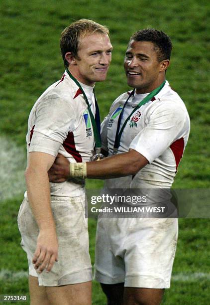 English winger Jason Robinson and scrumhalf Matt Dawson celebrate after the Rugby World Cup 2003 final between Australia and England at the Olympic...