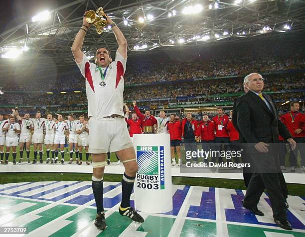 Martin Johnson the captain of England holds aloft the William Webb Ellis trophy after England's victory in the Rugby World Cup Final match between...