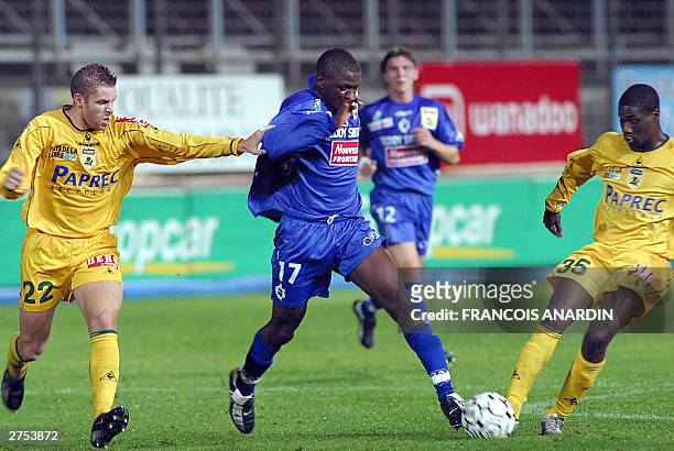 Bastia's midfielder Franck Matinguou vies with Nantes' defender Sylvain Armand and Ivorian midfielder striker Emerse Fae during their French L1...