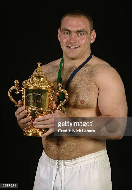 Trevor Woodman of England poses for a photograph with the webb Ellis Trophy after winning the Rugby World Cup Final between Australia and England at...