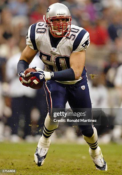 Linebacker Mike Vrabel of the New England Patriots intercepts a pass in overtime against the Houston Texans at Reliant Stadium on November 23, 2003...