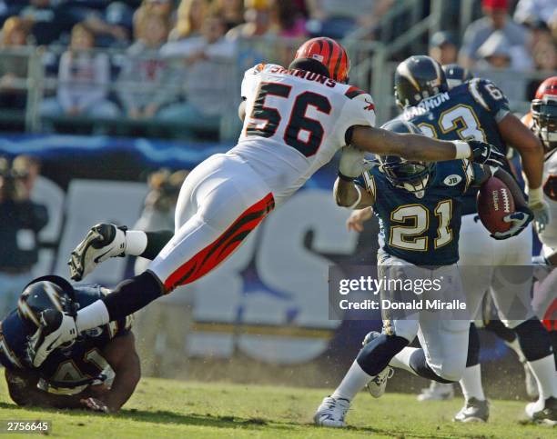 Brian Simmons of the Cincinnatti Bengals jumps to tackle LaDainian Tomlinson#21 of the San Diego Chargers in the 1st half during their NFL game on...