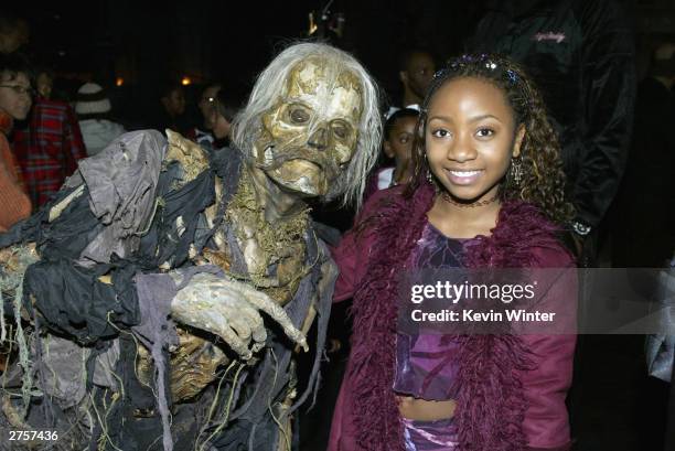 Actress Aree Davis poses with a ghoul at the after-party for "The Haunted Mansion" at the El Capitan Theater on November 23, 2003 in Los Angeles,...