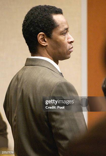 Convicted sniper John Allen Muhammad stands as the jury recommendation of death is read in courtroom 10 at the Virginia Beach Circuit Court November...