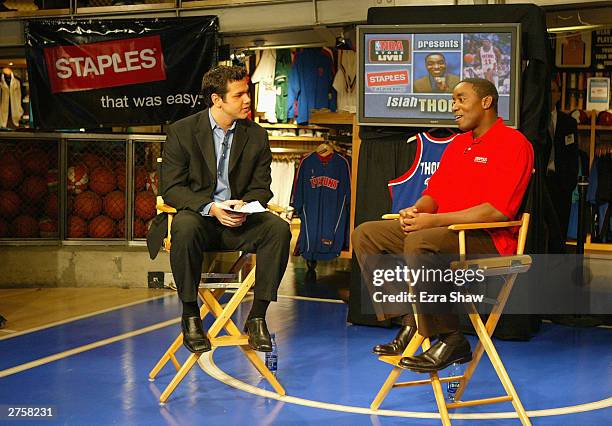 Isiah Thomas speaks with NBA anchor Spero Dedes on November 24, 2003 at the NBA store in New York City. Thomas is promoting the "Staples VIP All-Star...