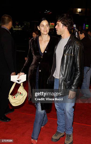 Actress Carrie-Anne Moss and husband Steven Roy attend the premiere of "The Cooler" held on November 24, 2003 at the Egyptian Theater, in Los...