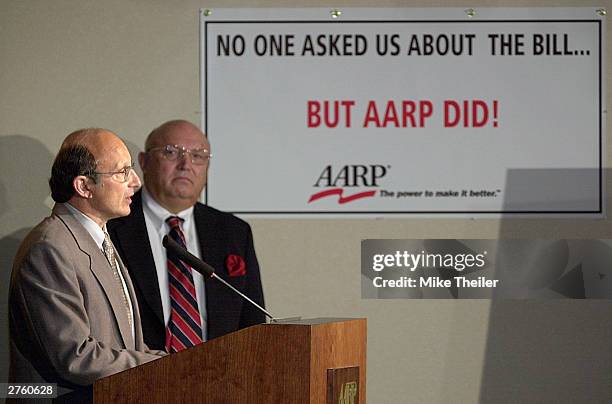 Bill Novelli makes remarks as AARP President Jim Parkel listens at a media conference in reaction to the Medicare vote before Congress November 25,...