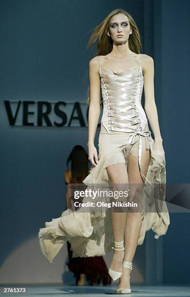 Model wearing a dress from the Versace collection walks the runway during the opening of Moscow Fashion Week on November 25, 2003 in Moscow.
