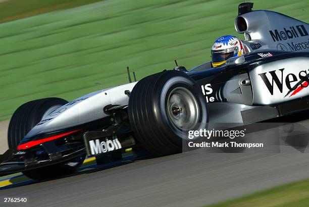 Alex Wurz of Austria and the McLaren team drives the new MP4-19 during Formula One testing at the Ricardo Tormo circuit on November 26, 2003 in...