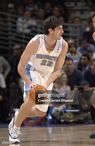 Nikoloz Tskitishvili of the Denver Nuggets moves the ball during the game against the Milwaukee Bucks at the Pepsi Center on November 19, 2003 in...