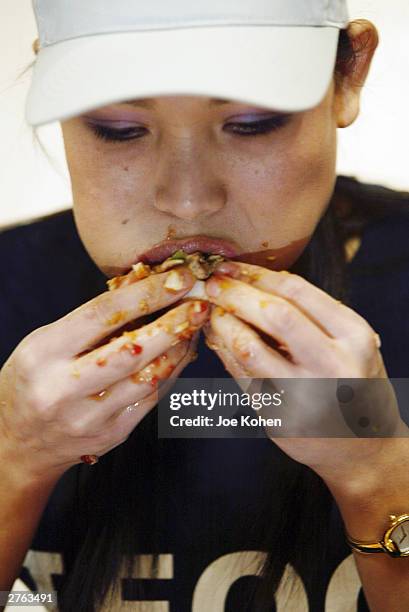 Sonya Thomas, 36-years-old and 100 pounds, stuffs her mouth during a Thanksgiving eating competition November 26, 2003 at Mickey Mantle's Restaurant...
