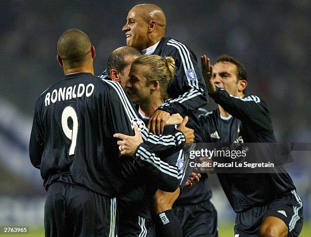 Zinedine Zidane and Ronaldo congratulate David Beckham of Real Madrid after he scored the first goal during the UEFA Champions League Group F match...