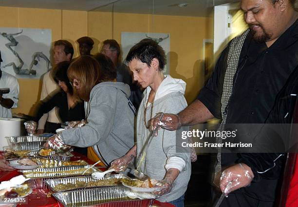 Actresses Penny Marshall and Lori Petty serve food at A Place Called Home, which provides at-risk youth with "a secure, positive family environment"...
