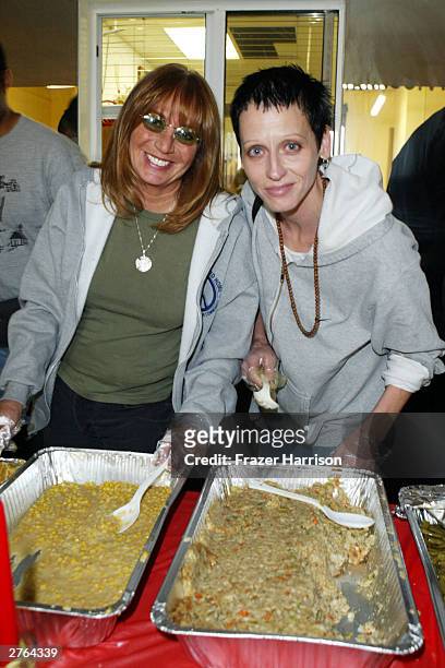 Actress/Producer Penny Marshall and actress Lori Petty serve food at A Place Called Home, which provides at-risk youth with "a secure, positive...