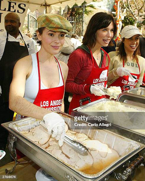 Actresses Alyssa Milano and Jennifer Love Hewitt serve up a Thanksgiving dinner to homeless people at the Los Angeles Mission annual turkey dinner...