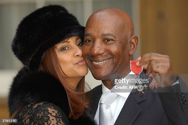 Hot Chocolate singer Errol Brown with his wife Ginette after receiving an MBE, for services to pop music, from Queen Elizabeth II at Buckingham...