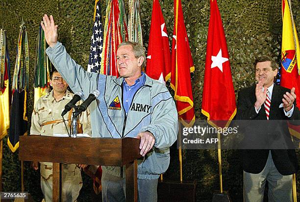President George W. Bush , accompanied by commander of the US forces in Iraq Lt. Gen. Ricardo Sanchez and US Administrator for Iraq Paul Bremer,...