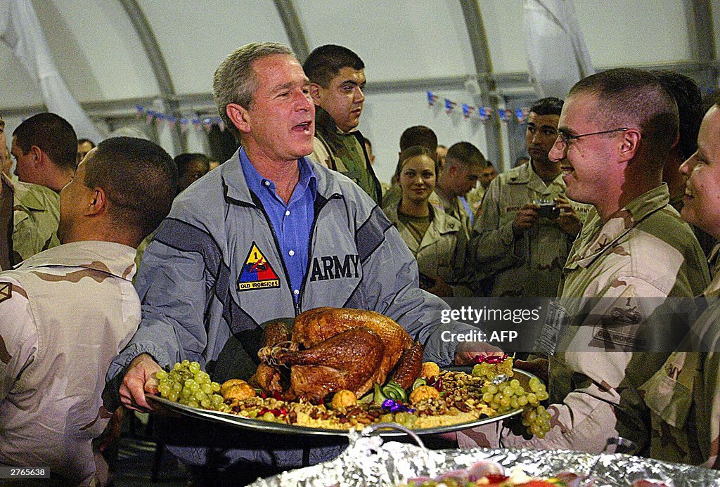 US President George W. Bush carries a pl