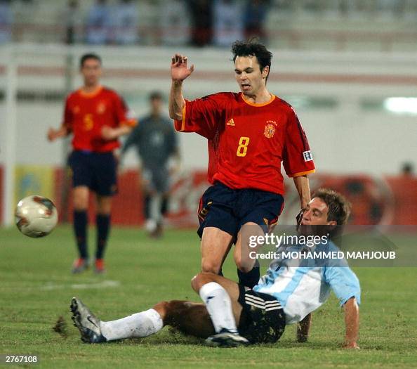 Spaniard Iniesta (standing) is tackled b Spaniard Iniesta (standing) is tackled b