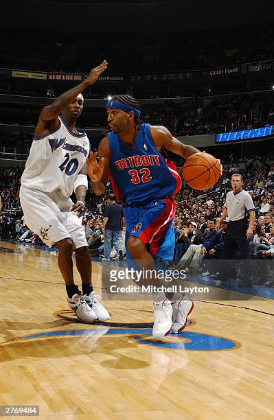 Richard Hamilton of the Detroit Pistons dribbles around Larry Hughes of the Washington Wizards during a game November 29, 2003 at the MCI Center in...