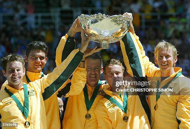 Australian's team Todd Woodbridge, Mark Philippoussis, captain John Fitzgerald, Lleyton Hewitt and Wayne Arthurs hold the Davis Cup, after winning...