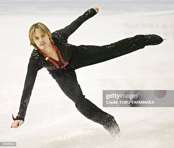 Alexander Abt of Russia keeps his balace when he lands on the ice during the free skating of men's singles event in the NHK Trophy figure skating...