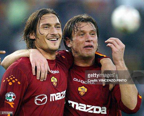Roma's captain Francesco Totti celebrates together with his teammate Antonio Cassano after scoring against Lecce during their Serie A soccer match at...