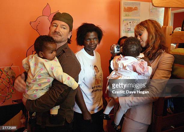 Singer Bono and singer Beyonce Knowles visit the Baphumelele orphanage for children with AIDS whose parents have died of AIDS prior to the "46664...