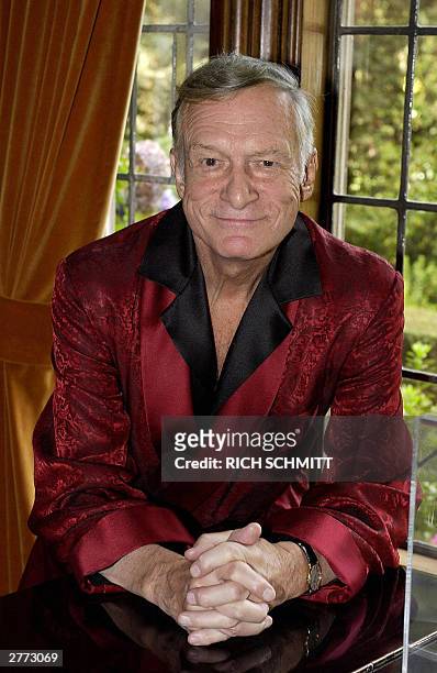 Playboy magazine founder Hugh Hefner poses at his Los Angeles, California home, 19 November, 2003. Fifty years after Hefner launched Playboy and a...