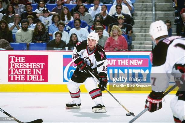 Leftwinger Randy Burridge of the Buffalo Sabres moves the puck during a game against the Pittsburgh Penguins at the Marine Midland Arena in Buffalo,...