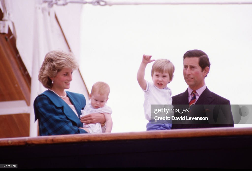 Diana Princess of Wales and Charles Prince of Wales hold Prince Harry and Prince William on the deck of the Royal Yacht Britannia