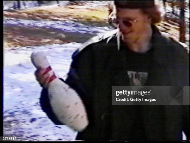 Dylan Klebold examines a shot-up bowling pin used for target practice at a makeshift shooting range March 6, 1999 in Douglas County, CO in this image...