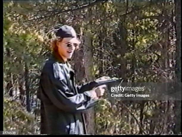 Dylan Klebold fires a sawed-off shotgun at a makeshift shooting range March 6, 1999 in Douglas County, CO in this image from video released by the...