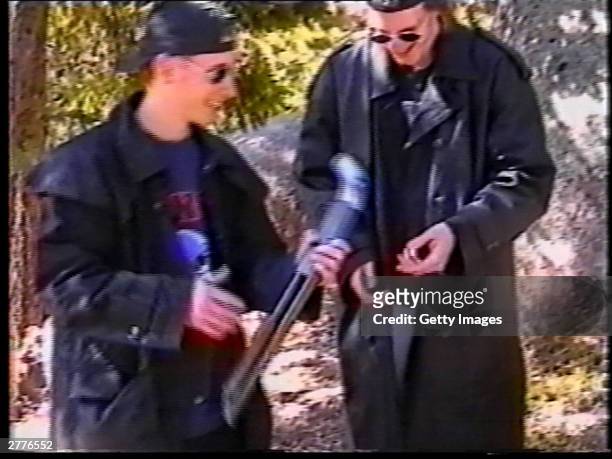Eric Harris and Dylan Klebold examine a sawed-off shotgun at a makeshift shooting range March 6, 1999 in Douglas County, CO in this image from video...