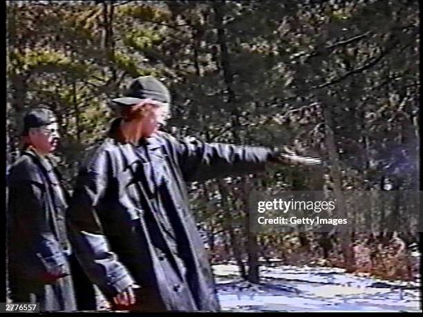 Eric Harris watches as Dylan Klebold practices shooting a gun at a makeshift shooting range March 6, 1999 in Douglas County, CO in this image from...