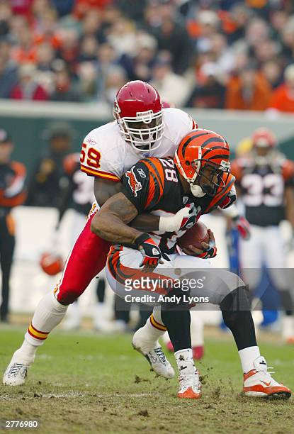 Corey Dillon of the Cincinnati Bengals is tackled by linebacker Shawn Barber of the Kansas City Chiefs during the game at Paul Brown Stadium on...