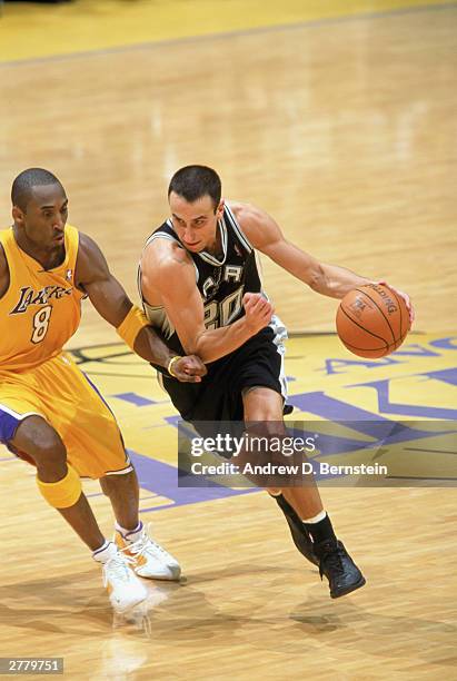 Emanuel Ginobili of the San Antonio Spurs drives against Kobe Bryant of the Los Angeles Lakers at Staples Center on November 28, 2003 in Los Angeles,...