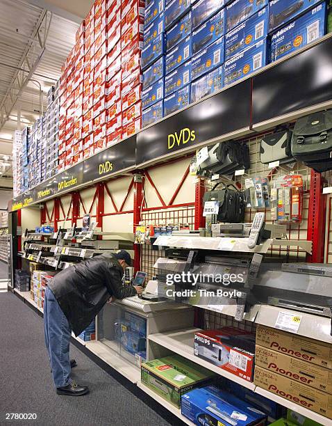 Shopper looks at DVD players December 3, 2003 at a Best Buy store in Niles, Illinois. Electronics are the big items this holiday shopping season.